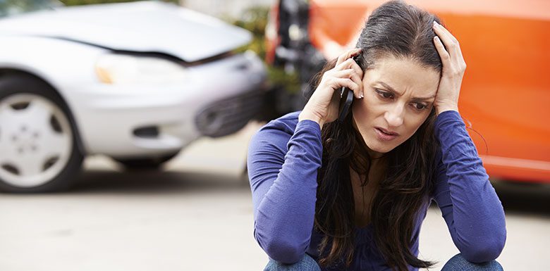 woman on phone after car accident
