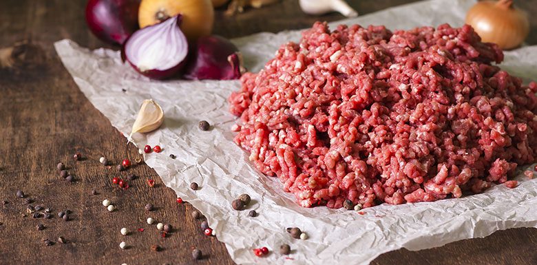 Ground beef with garlic and onions on paper