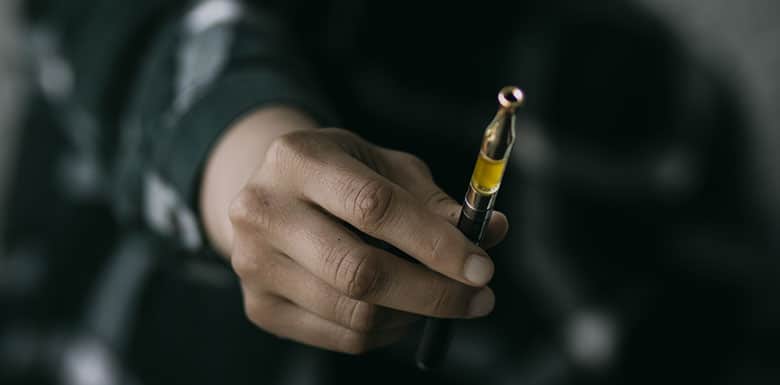 Person holding out vape pen
