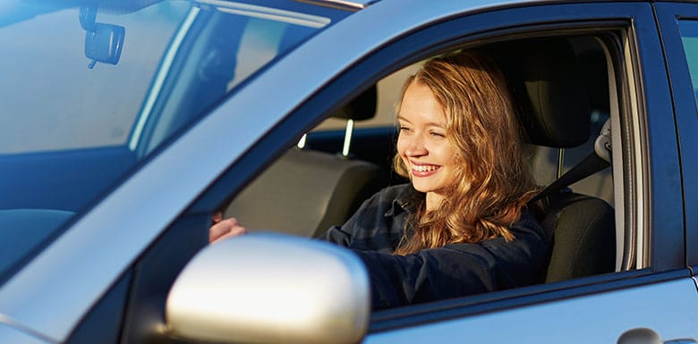 Woman smiling as she drives