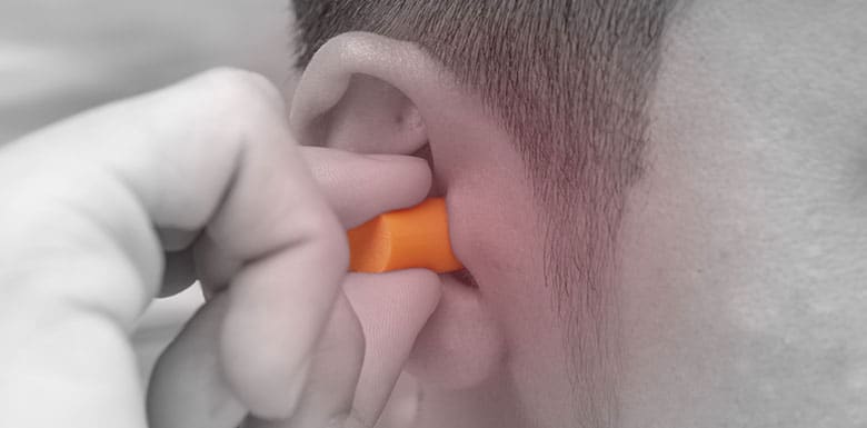 Man putting in 3m ear plugs