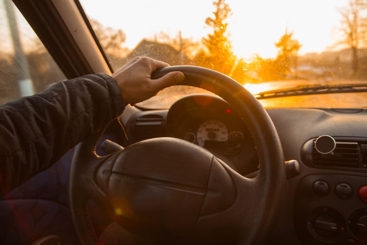 man holding steering wheel