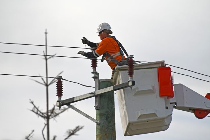 Female electricity worker fixing power line