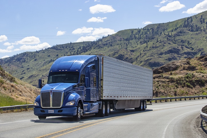 truck on highway in front of mountain