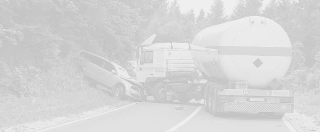 Tanker and SUV collision on a road bordered by trees. The SUV is off-road, while the tanker is partially on the pavement. Debris is scattered near the vehicles.