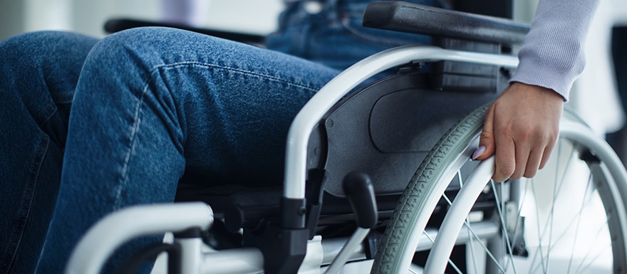 Long term damages of a spinal cord injury. Person using a wheelchair.